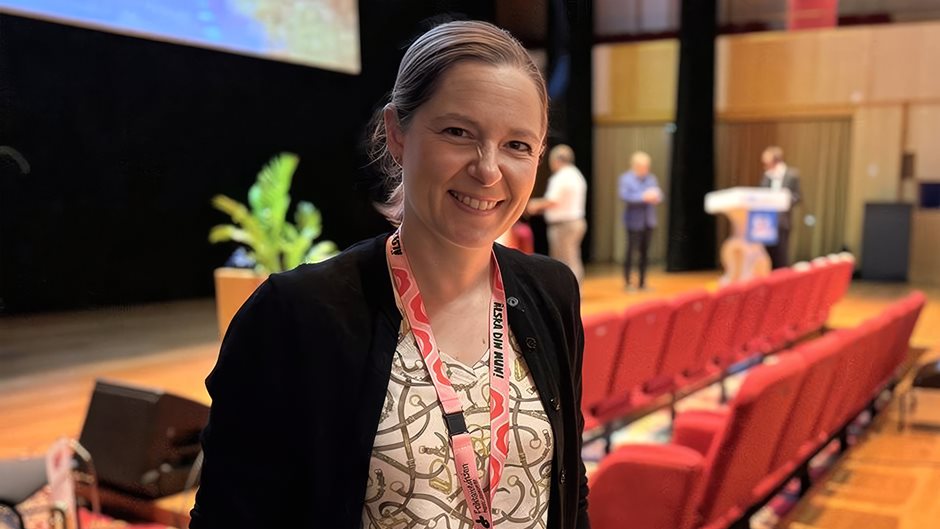 Leende kvinna i halvfigur i konferensmiljö
